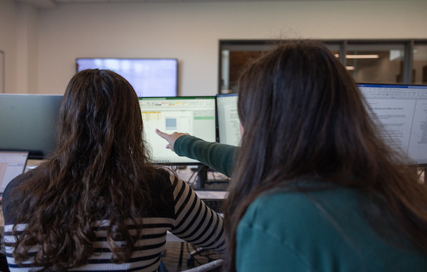 Students discussing in the trading lab