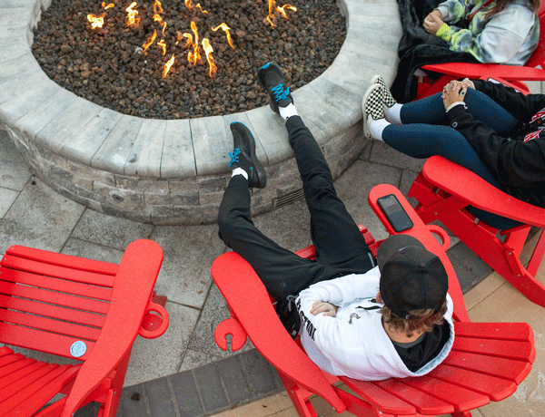 Student sitting at the fire pit