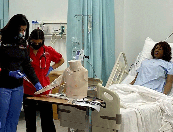 photos of nursing students with a mannequin
