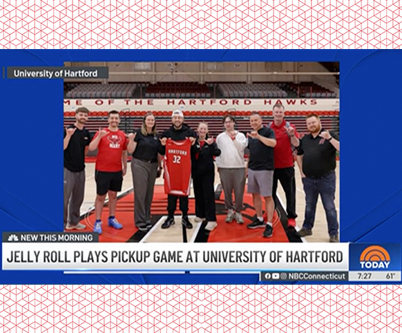 line of people posing on an indoor basketball court