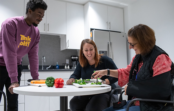 therapist working in kitchen with patient