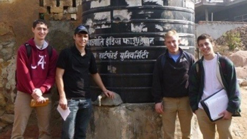 students in front of home in India