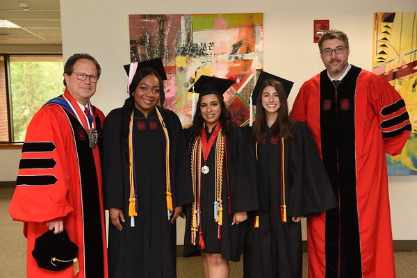 President Gregory Woodward, student award winners Aaliyah Booker, Jaileene Arriaga, Destynie Medeiros, and speaker Orin Wolf '01