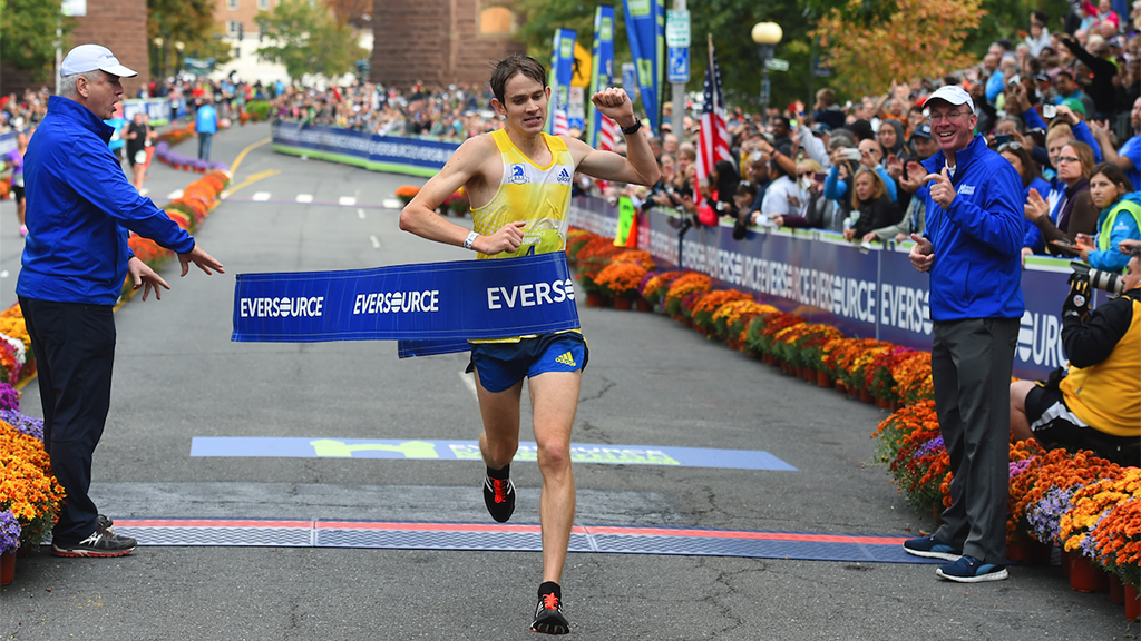 runner crossing finish line at Hartford Marathon