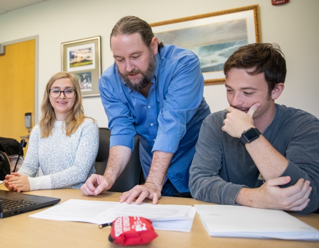 Professor working with students.