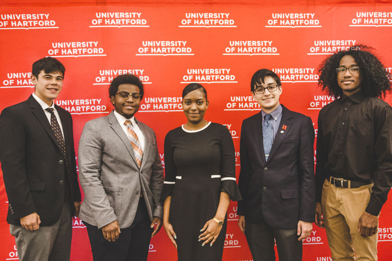 students in front of banner