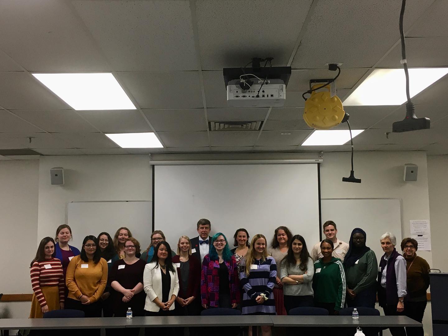 individuals standing in classroom