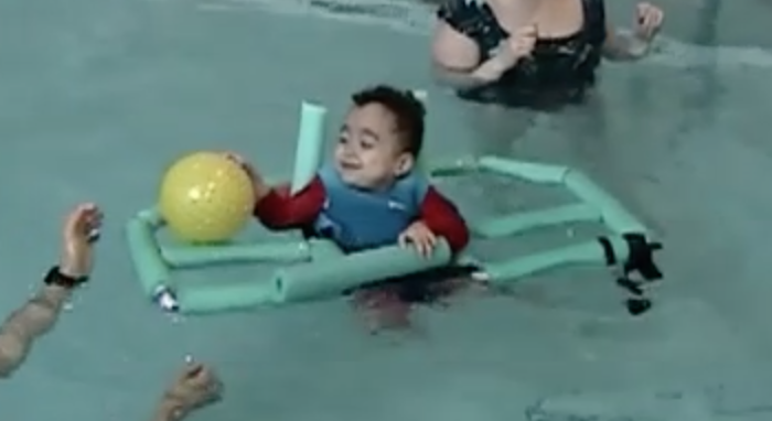 JR Ellis plays in the pool using the Water Strider