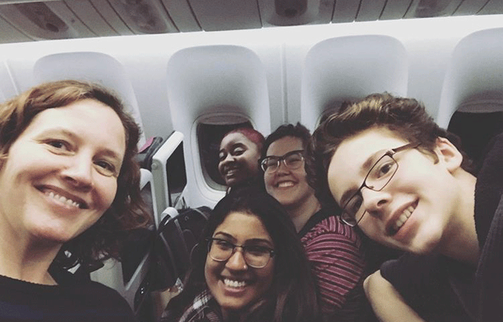 Associate Professor Katharine Owens and her students on a plane to India