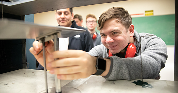 student working on a wind tunnel machine