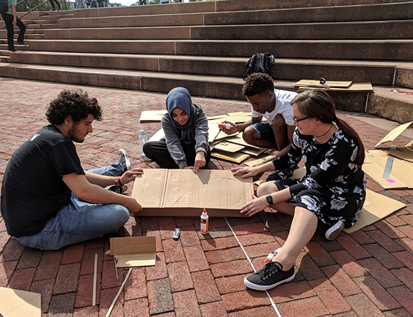 student drawing outside on campus