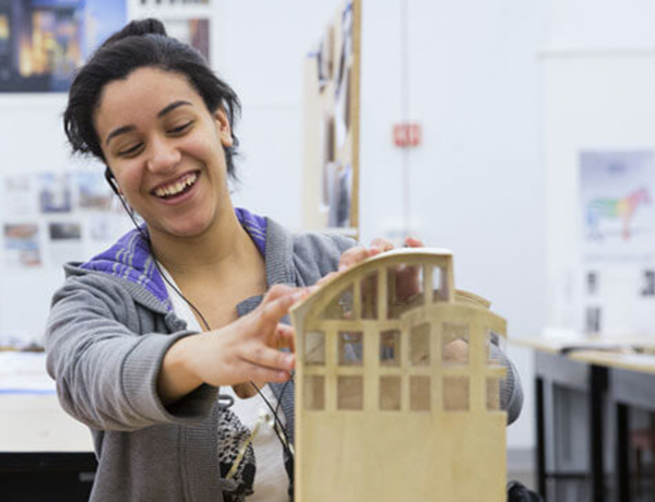 young female student working on wood structure design