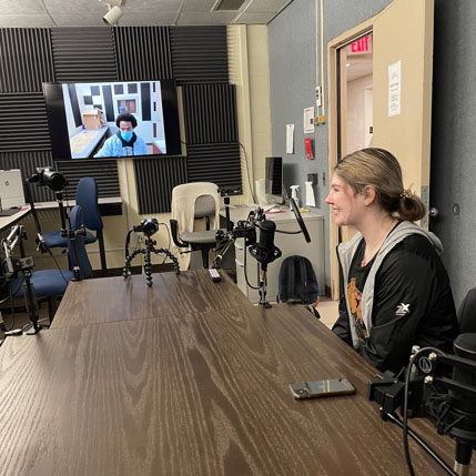 Student working in podcasting studio.