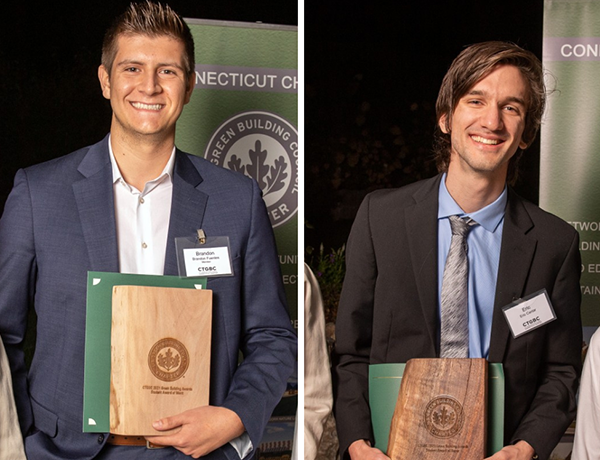 two males standing with wood plaque awards