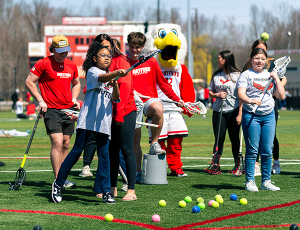 children play lacrosse