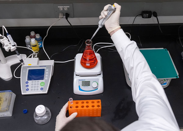 UHart student conducting research in a lab on campus