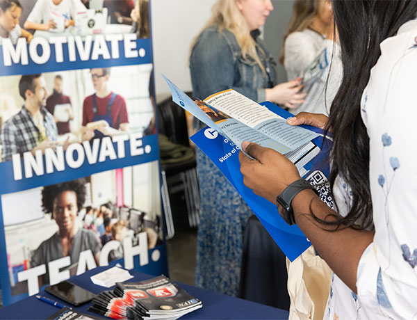 Image of student looking at materials at the CT State Career Fair
