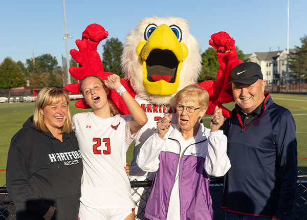 UHart family celebrating a win with Howie at Hawktober
