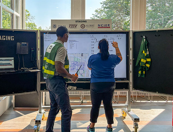 UHart staff viewing a whiteboard