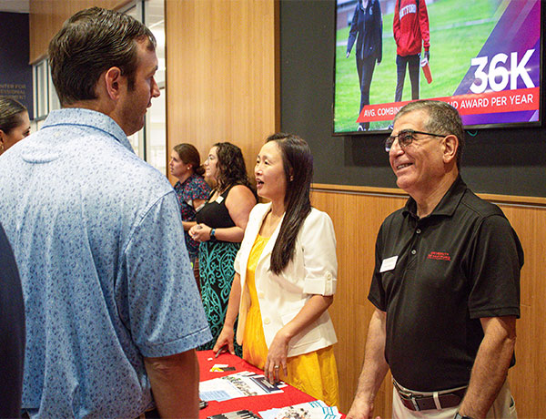 CETA Dean Hisham Alnajjar speaks with someone at the event