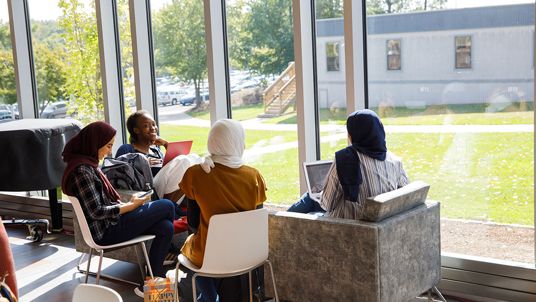 UHart students sitting together in GSU Hawk Lounge