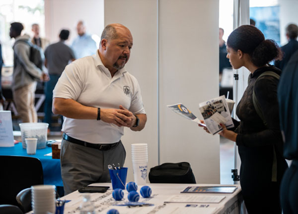 employer speaking to student at the career fair