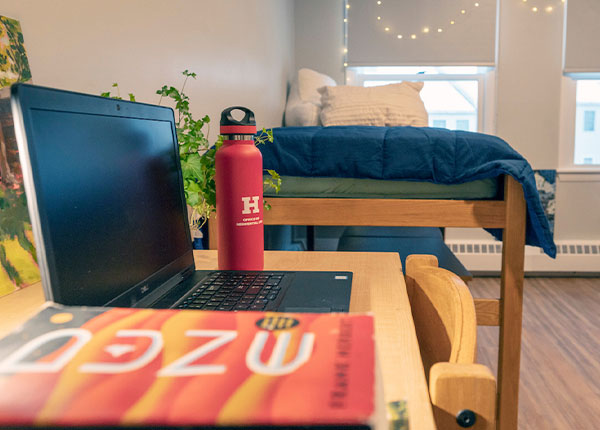 gender-inclusive dorm room with UHart water bottle on the desk