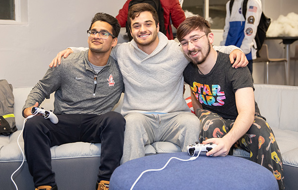 students playing video games in their dorm