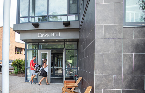 students walking into Hawk Hall