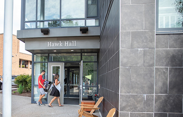 students walking into Hawk Hall