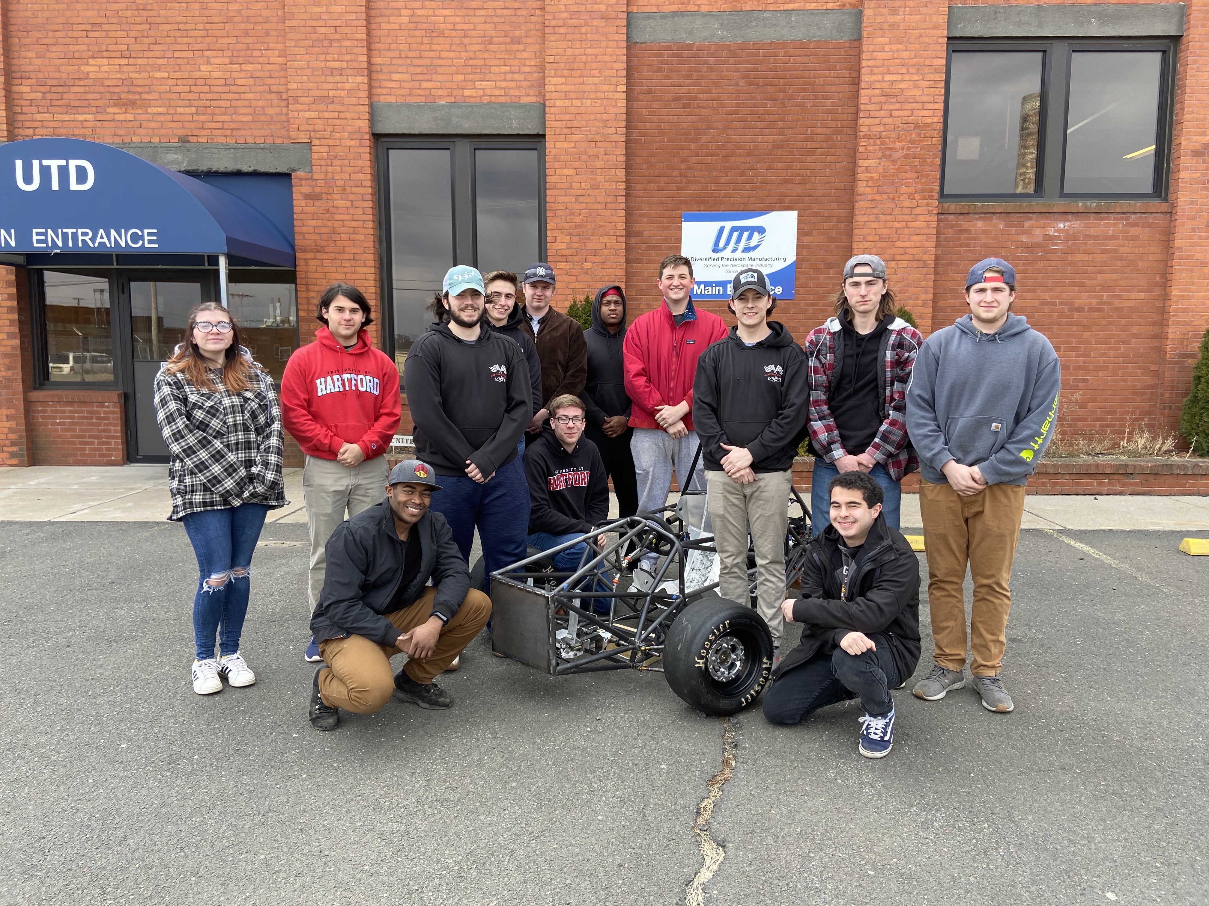 students standing with car