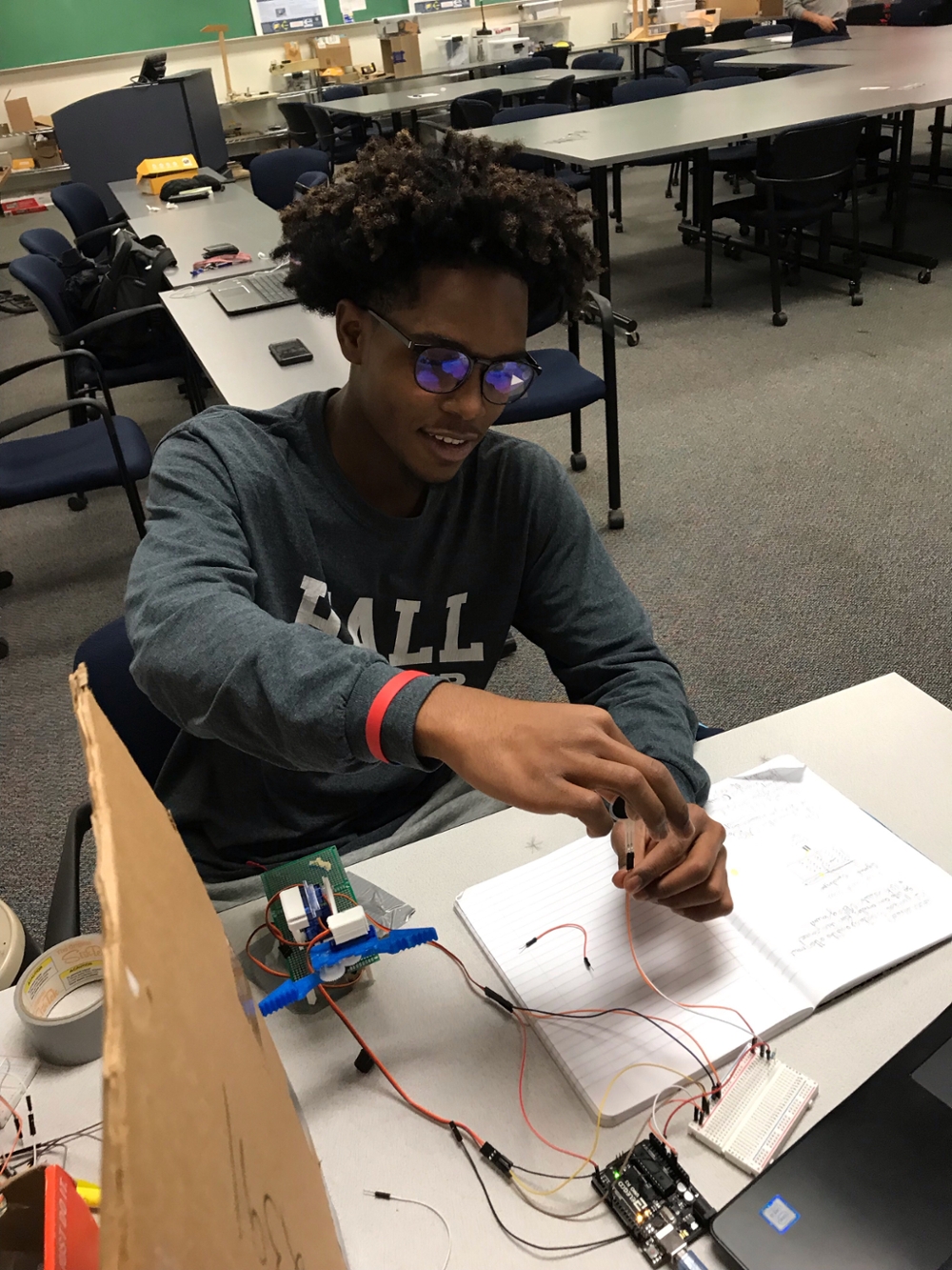 male student working on robot machine