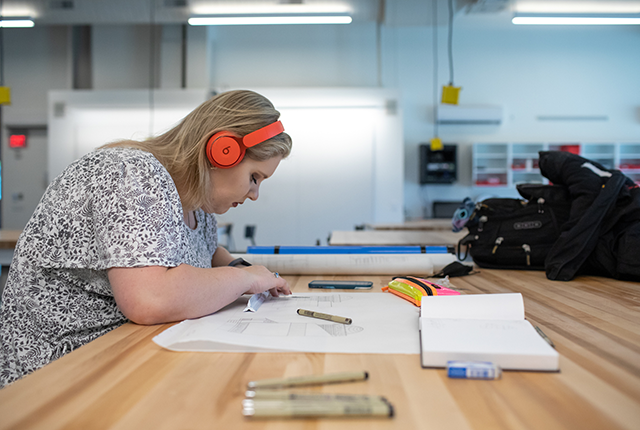 female student working on drawing design