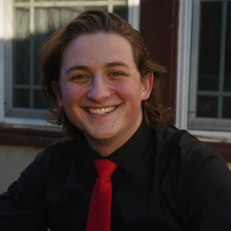 Portrait image of male student smiling.