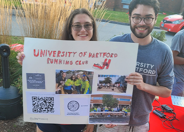 Running Club Members Holding Sign
