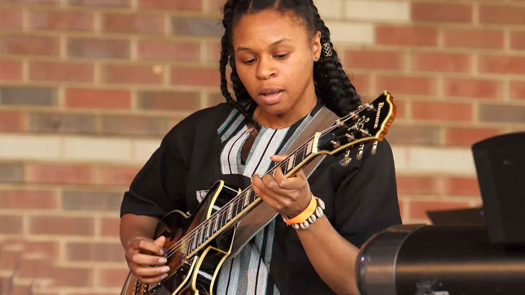 female playing guitar