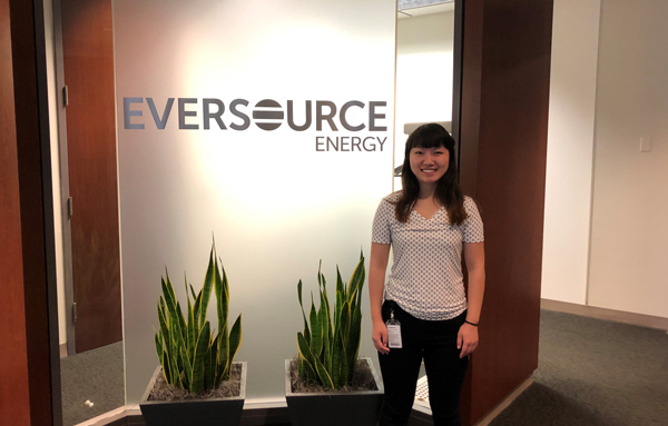 Lydia standing in front of Eversource sign