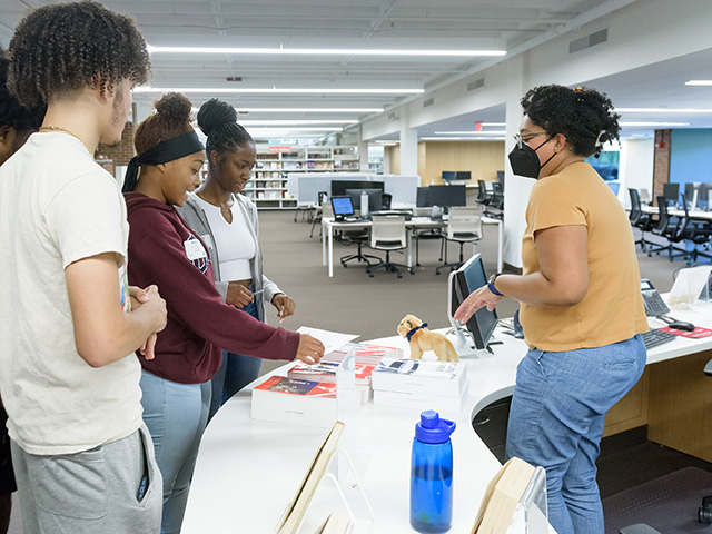 Students at a library counter