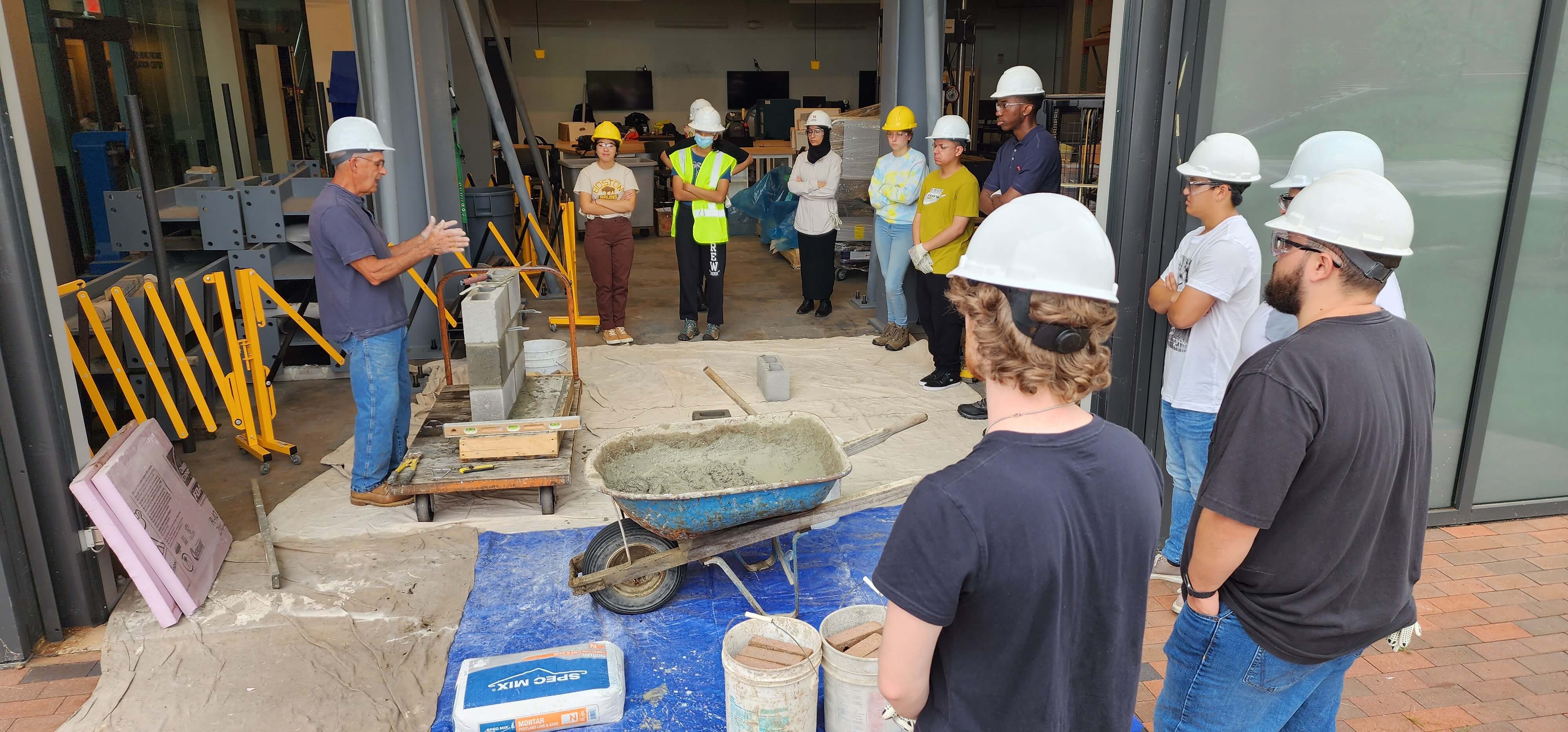 students hearing from an industry professional about building a brick wall