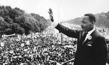 historical image of MLK waving to a crowd