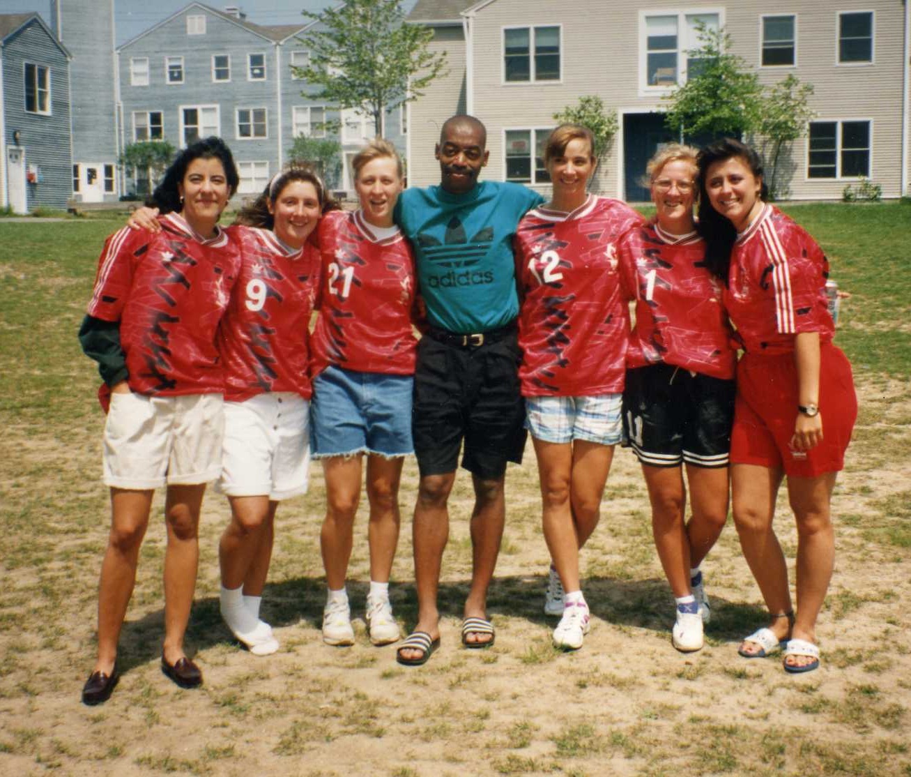 Coach Austin Daniels surrounded by members of the University of Hartford women's soccer team